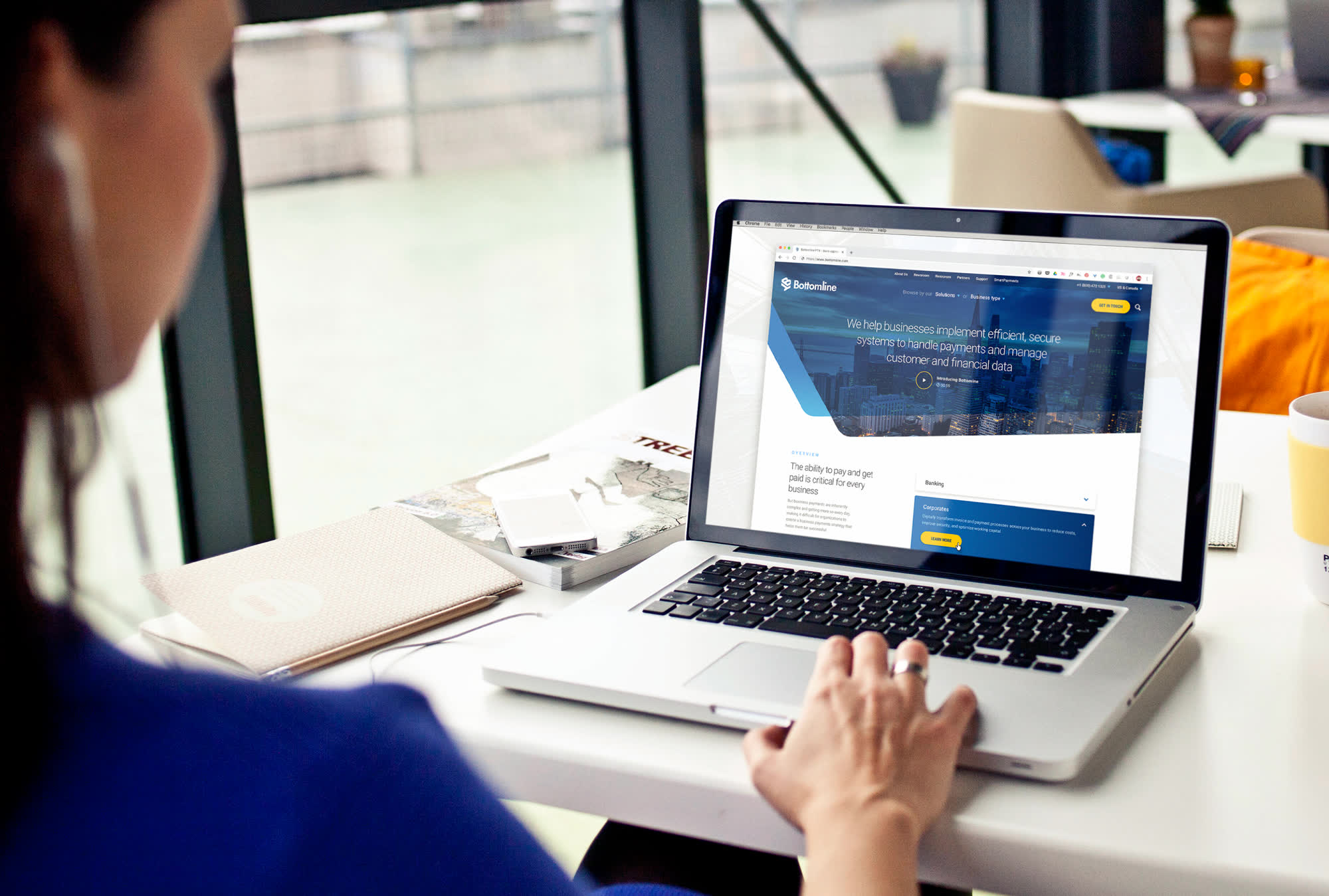 A woman on a laptop looking at a website.